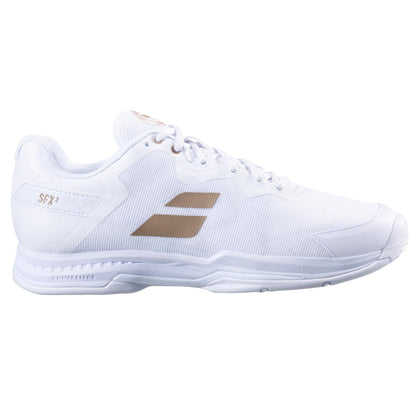 A sleek athletic shoe with a white design enhanced by gold accents and the Babolat brand name on the side. It features a Kompressor System for improved cushioning, a textured sole, and white laces—a perfect mix of style and performance, making it ideal for any sports enthusiast.
