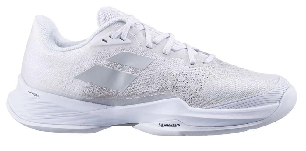 Introducing the Babolat Jet Mach 3 All Court Mens Tennis Shoes in White and Silver. These sleek athletic tennis shoes feature a lightweight mesh upper and a robust sole enhanced with Matryx Technology. They are designed with gray accents, including the logo, along with intricate texture details that provide breathability and shock absorption comfort.