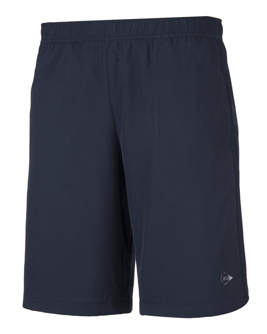 A pair of navy blue woven tennis shorts from the Dunlop Club Line collection, crafted from a polyester-spandex blend. These knee-length shorts feature an elastic waistband for an adjustable fit and a small logo on the lower left side, offering a slightly loose fit that is perfect for comfort and performance on the court.