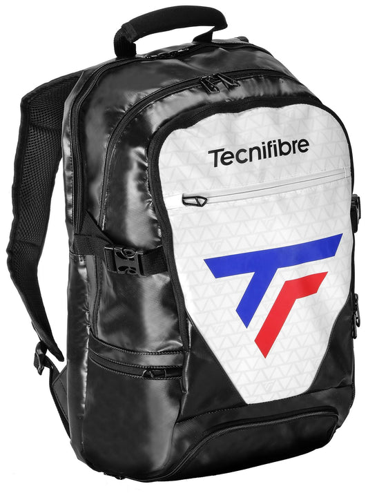 The Tecnifibre Tour Endurance RS Tennis Backpack, available in white and black, features padded shoulder straps and multiple compartments. The front pocket showcases a geometric logo in blue and red along with the Tecnifibre brand name. It also includes locking zippers for enhanced security and is made from reinforced tarpaulin to ensure durability.