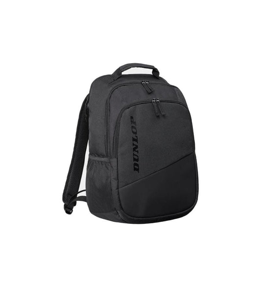 Displayed is the Dunlop Team Tennis Backpack - Black, featuring multiple compartments, zippers, a top handle, padded shoulder straps, and a side mesh pocket. The brand "Dunlop" is vertically printed on the front pocket, ensuring excellent racket protection for players on the go.