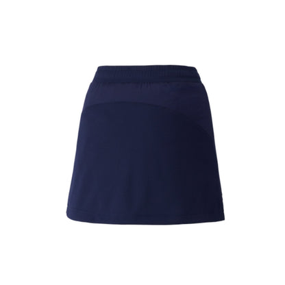 The Yonex 26094 Women's Skort by Yonex showcases a high-waisted, navy blue pleated design with a subtle A-line silhouette, incorporating VERY COOL TECHNOLOGY for maximum comfort, all set against a simple white backdrop.