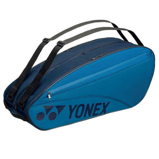The Yonex 42326EX 6 Piece Racket Bag in sky blue boasts a sleek design with black zippers and adjustable shoulder straps, ideal for carrying multiple rackets. The iconic Yonex logo graces the side, adding a stylish flair.