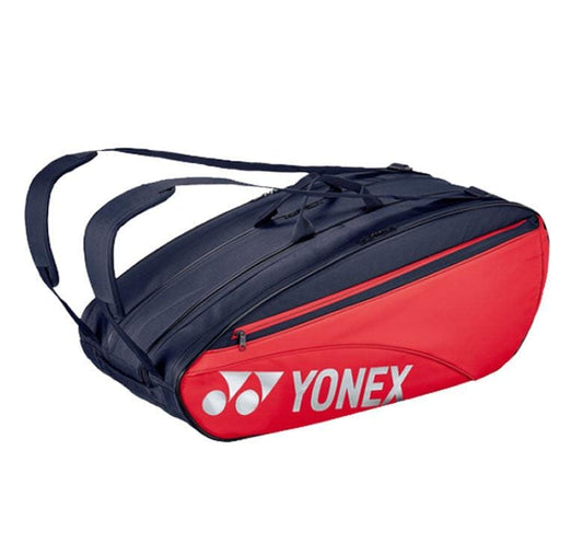 The Yonex 42329EX 9 Piece Racket Bag in Scarlet offers ample storage space and features multiple compartments along with comfortable shoulder straps. The Yonex logo is prominently displayed on the side.