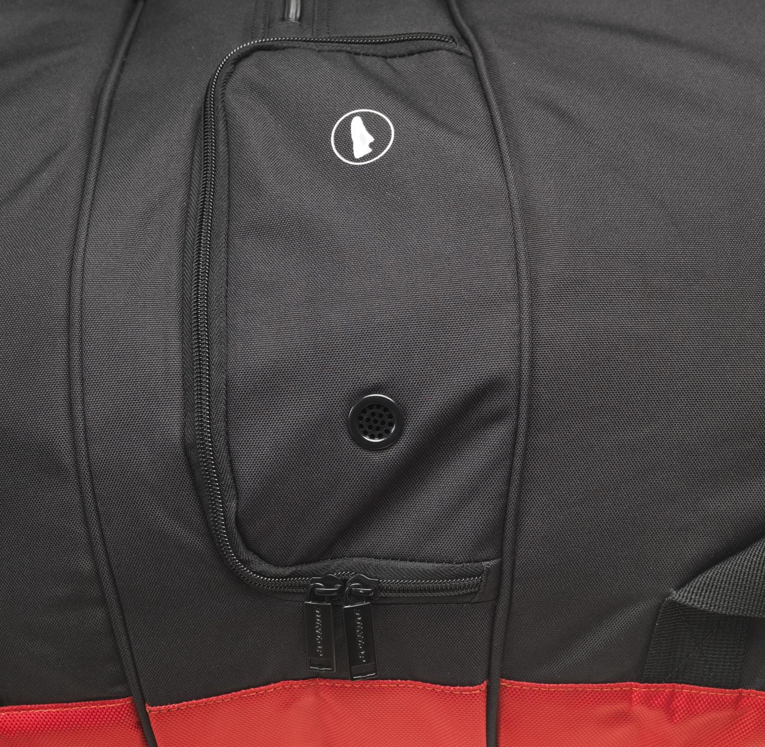 Close-up of a black and red Dunlop CX Performance 12 Racket Thermo Tennis Bag featuring a zippered pocket. The pocket showcases a small circular logo and a round mesh vent, with two black zipper pulls at the bottom, highlighting its capacity to hold up to 12 rackets.