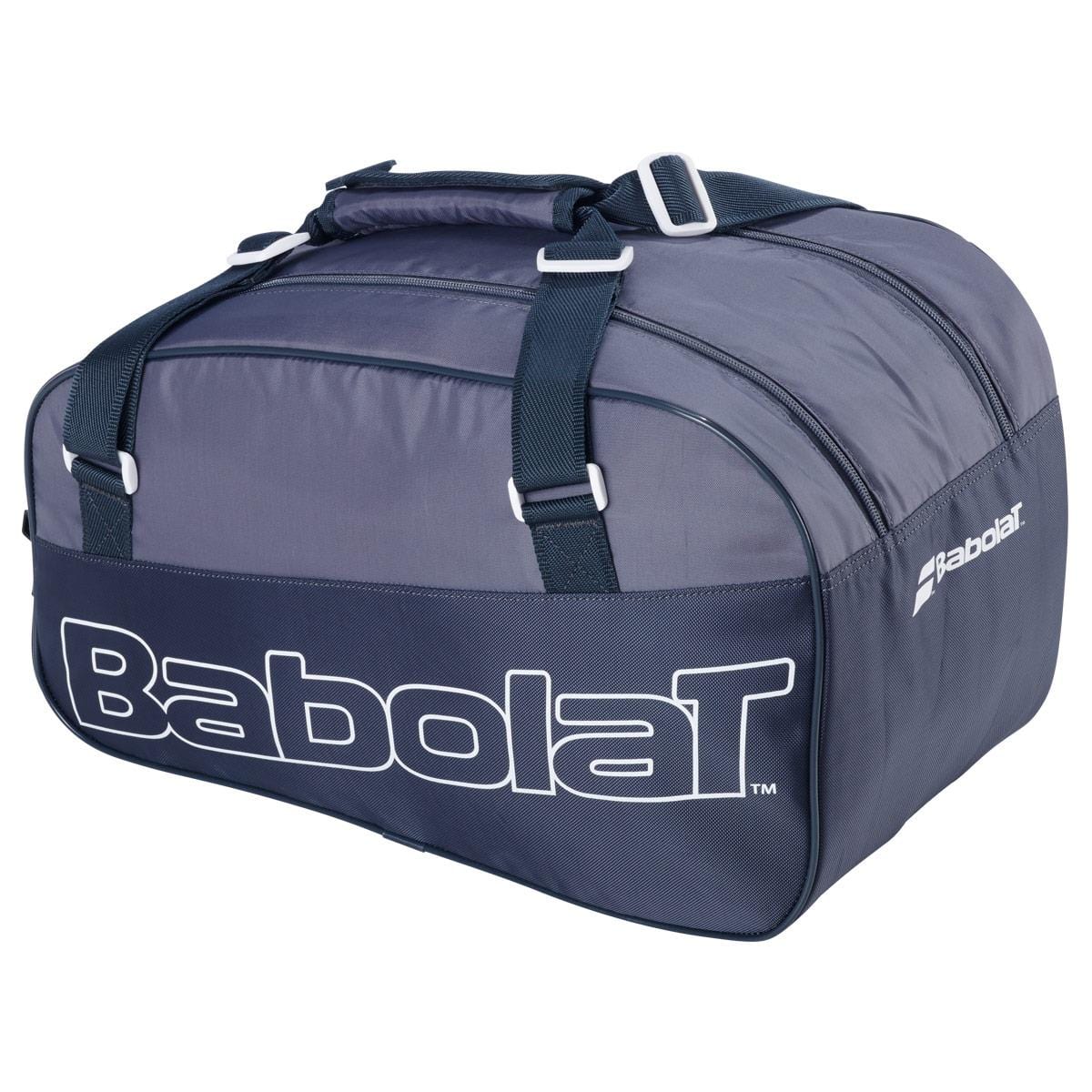 The Babolat Evo Court S Tennis Racket Bag in grey and blue is a spacious bag made from sturdy recycled materials, featuring dual handles and a zippered top. The brand's name, "Babolat," is prominently displayed in white on the side.