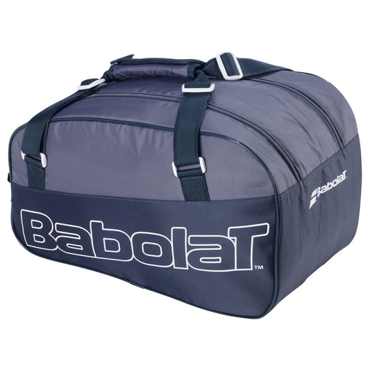The Babolat Evo Court S Tennis Racket Bag in grey and blue is a spacious bag made from sturdy recycled materials, featuring dual handles and a zippered top. The brand's name, "Babolat," is prominently displayed in white on the side.