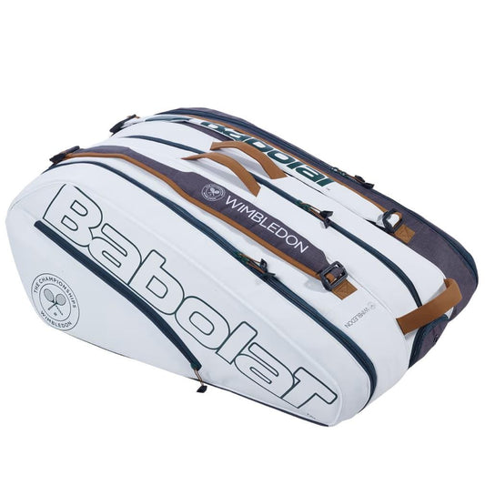 The Babolat RH12 Pure Wimbledon 12 Racket Tennis Bag stands out in white and grey, featuring the "Wimbledon" print. It offers multiple compartments with secure zipper closures and stylish beige handles, while circular logos enhance its chic design.