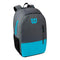 The Wilson Team Collection Tennis Backpack in Blue and Grey prominently displays the brand's iconic "W" logo and name on the front. It includes a racket pocket, a front zipper pocket, a side mesh pocket, and two shoulder straps for added convenience.