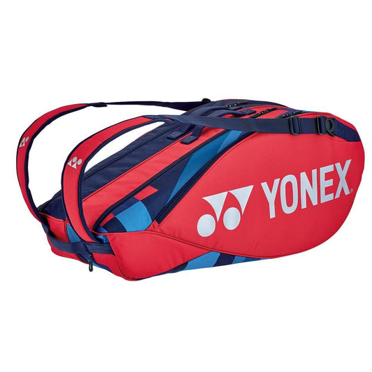 A scarlet Yonex 92226EX 6 Piece Pro racket bag with adjustable shoulder straps, several compartments, and the Yonex logo prominently displayed on the side.