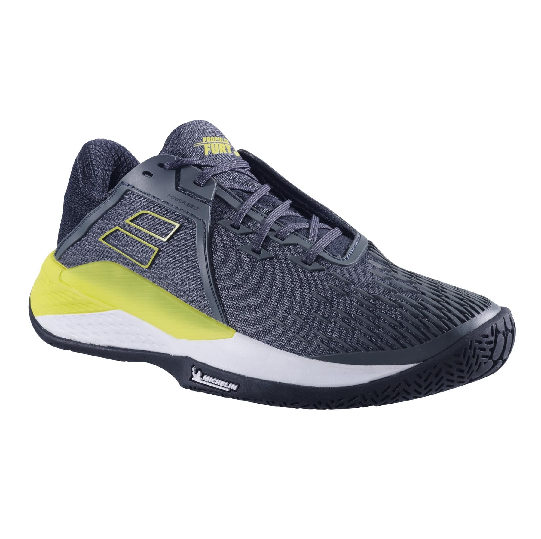 The Babolat Propulse Fury 3 All Court Men's Tennis Shoes in Grey/Aero are sleek dark gray footwear with a yellow accent. They feature textured materials and a prominent sole, showcasing the brand's logo on the side and heel. The design emphasizes performance and comfort through its innovative Power Belt technology.