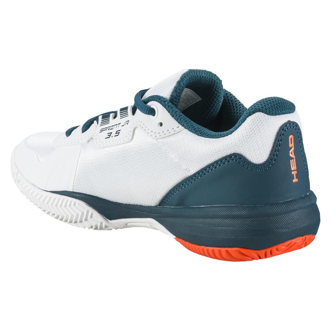 Introducing the HEAD Sprint 3.5 Junior Tennis Shoes in White and Orange, designed with breathable mesh for optimal comfort. This sporty, modern shoe showcases the "HEAD" logo on the heel, has a textured sole with orange accents, and features black laces, making it a perfect choice for junior tennis enthusiasts seeking a lightweight design.