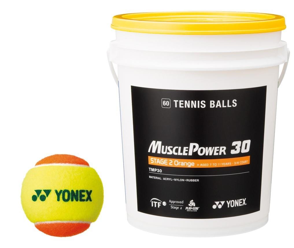 A Yonex bucket labeled "TB-TMP30" contains 60 Stage 2 Training Tennis Balls, ideal for skill development due to their slower pace. Nearby is a yellow and orange tennis ball from the same Yonex TB-TMP30 brand, adding a vibrant touch.