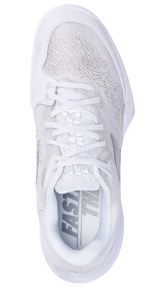 Top view of a white athletic tennis shoe from Babolat, the Babolat Jet Mach 3 All Court Men's Tennis Shoes in White/Silver, featuring Matryx Technology. The shoe displays textured fabric, white laces, and the word "FAST" inside. This sleek and modern design is complemented by subtle patterns on the upper material to enhance performance.