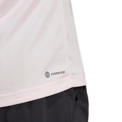 Close-up of a clear pink sports jersey featuring "AEROREADY" and a globe icon on the lower right side, hinting at its eco-friendly creation with recycled materials. The adidas Melbourne Men's Raglan Tennis T-Shirt is neatly tucked into black shorts, highlighting both style and sustainability.