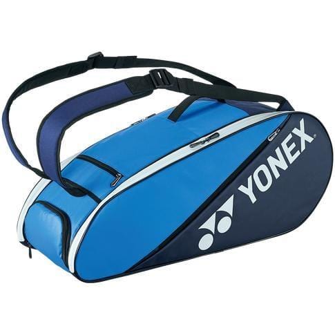The Yonex 82226EX 6 Piece Active Racket Bag in Blue and Navy features adjustable shoulder straps and a zippered side pocket. The prominently displayed Yonex logo enhances the style of this versatile sports duffel bag.
