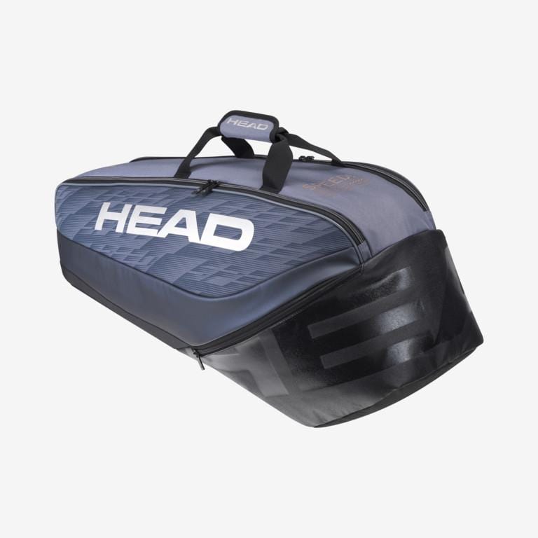 The HEAD Djokovic 6R Combi Tennis Bag in black and grey prominently displays "HEAD" and includes a durable top handle, generous storage for up to six rackets, along with CCT+ climate control technology to safeguard your gear from extreme temperatures.