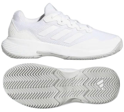 The adidas GameCourt 2 Women's Tennis Shoes in white are perfect for tennis enthusiasts, showcasing a side and bottom view. These sneakers feature a textured hard court outsole, mesh detailing, and the iconic three subtle stripes on the side characteristic of adidas branding.