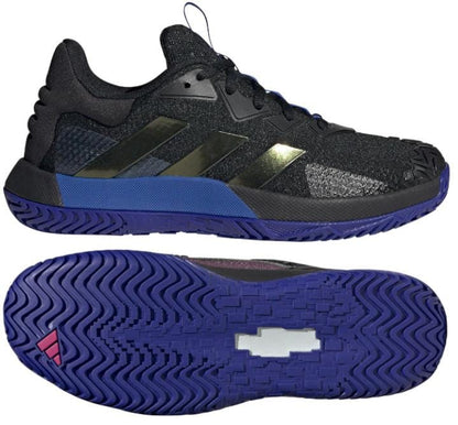 Introducing the adidas SoleMatch Control Men's Tennis Shoes in Black and Blue, designed by adidas. Featuring Bounce Cushioning technology for superior comfort and dark blue soles, these shoes sport metallic accents that highlight the textured upper. The zigzag pattern on the soles ensures optimal grip, while a unique slanted stripe design adds both style and abrasion resistance.