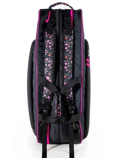 The Prince Hydrogen Lady Mary 6 Racket Tennis Bag in black and pink, featuring pink floral patterned straps and multiple compartments, resembles a fashionable tennis bag with a stylish design. It includes a pink handle at the top and is showcased against a white background.